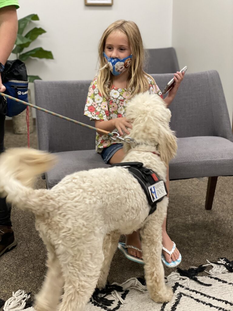 service dog with child at doctors office